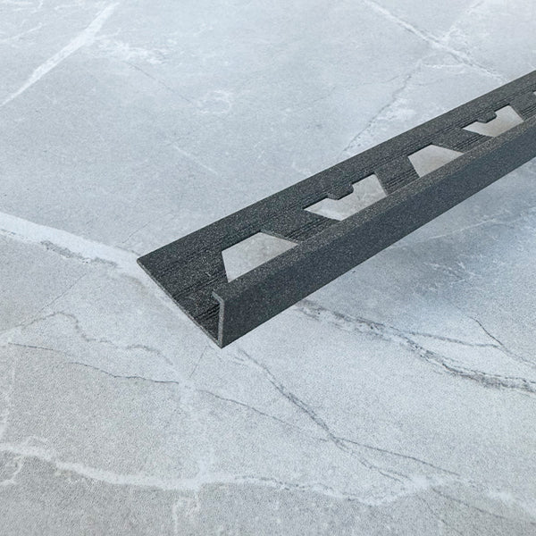 A-Trim Square Edge tile trim installed example — close-up of the trim capping the edge of an installed wall tile.
