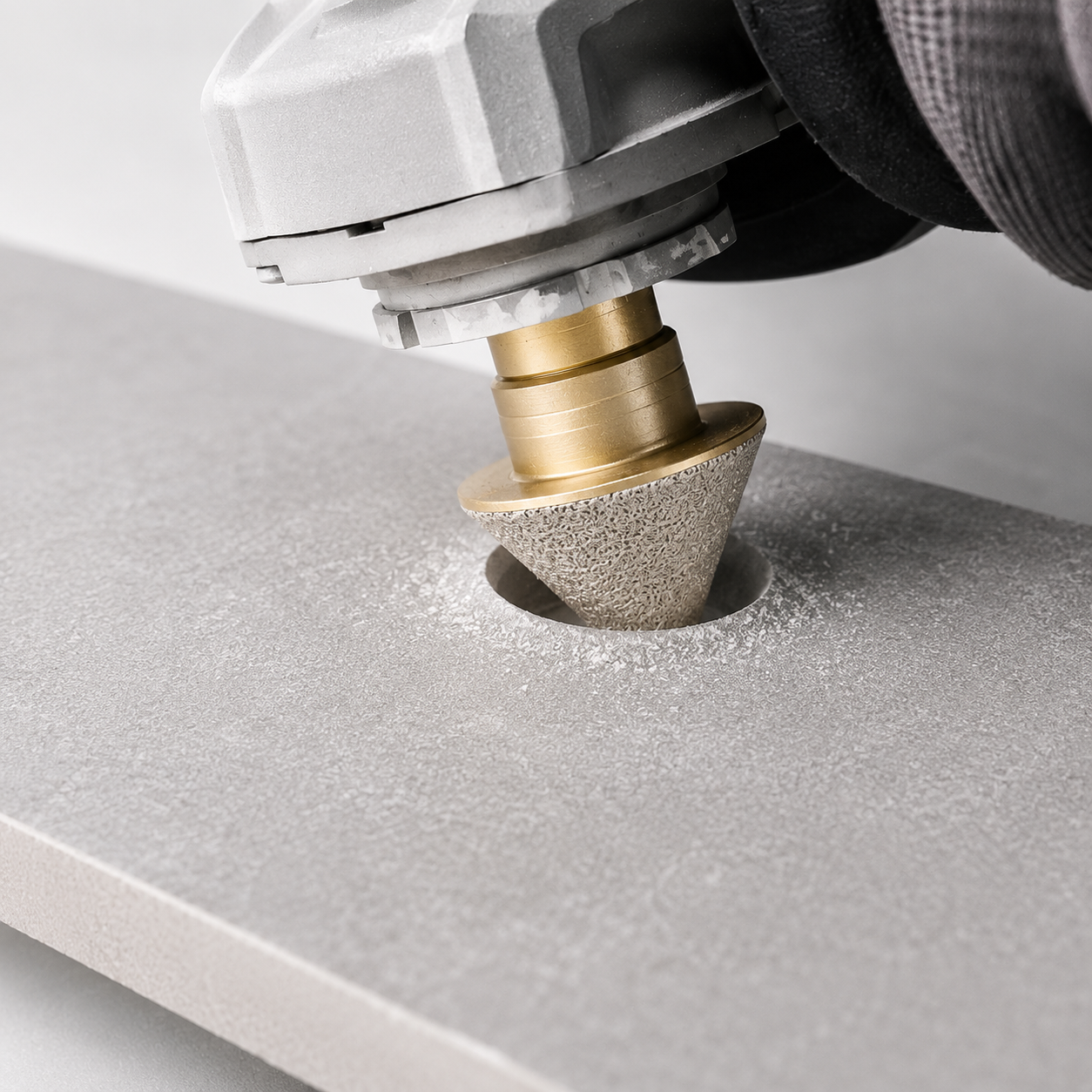 MILLCOT M14 Diamond Cone Bit in use enlarging a hole in tile