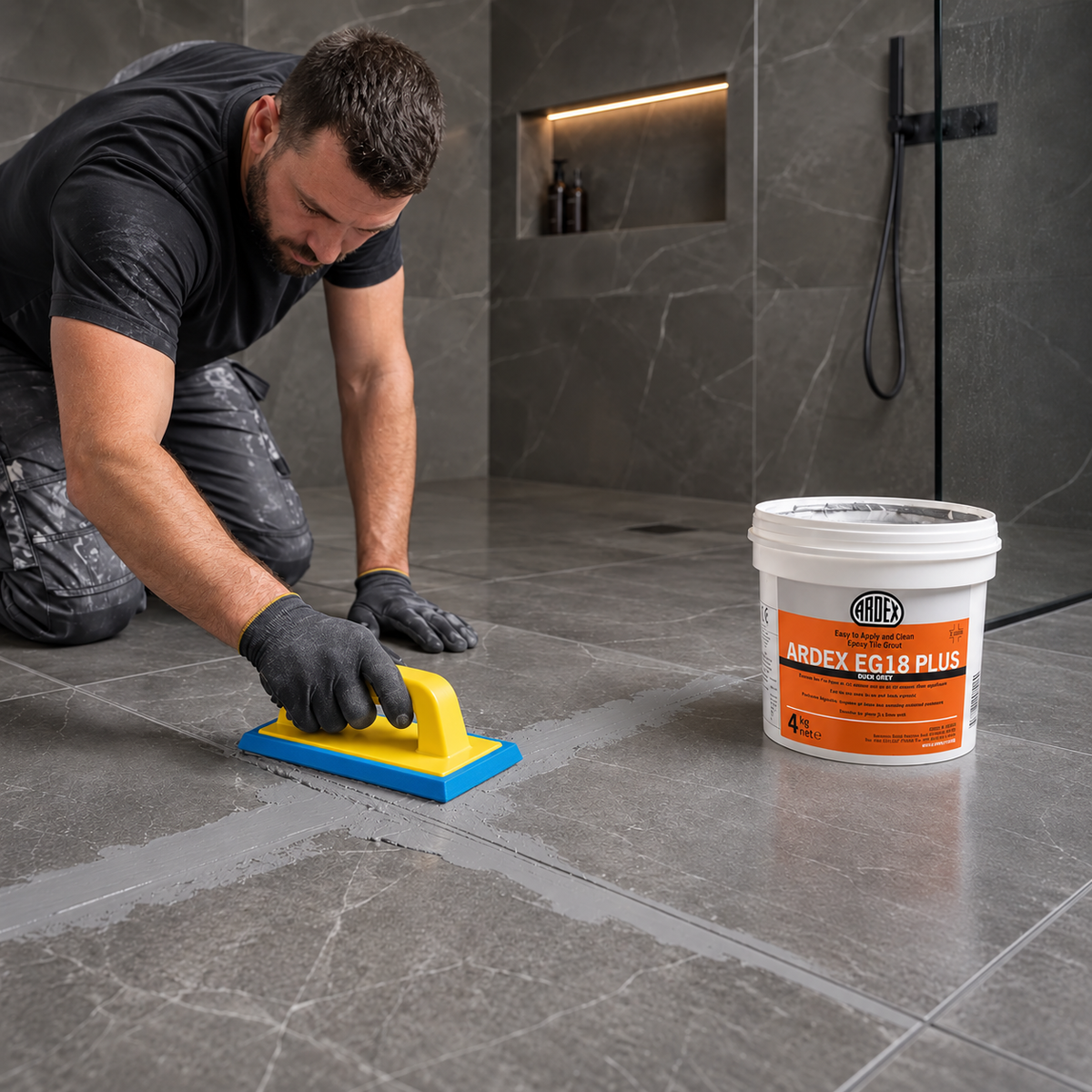 Tiler applying ARDEX EG18 epoxy grout to a bathroom floor with a Raimondi 1430 grout float