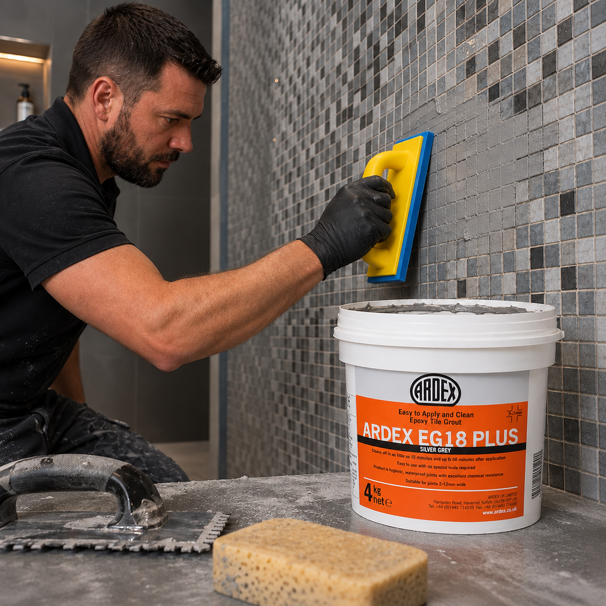 Tiler applying ARDEX EG18 epoxy grout to mosaic wall tiles with a Raimondi 1430 grout float