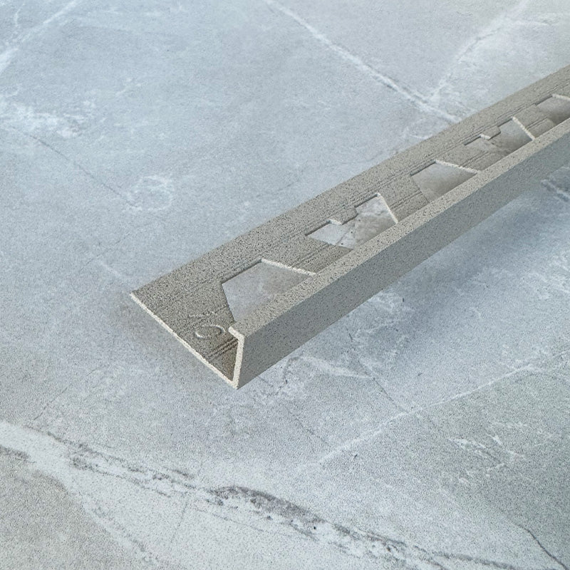 A-Trim Square Edge tile trim cross-section close-up — end-on view showing the squared edge profile and the tile-channel that seats the tile edge.