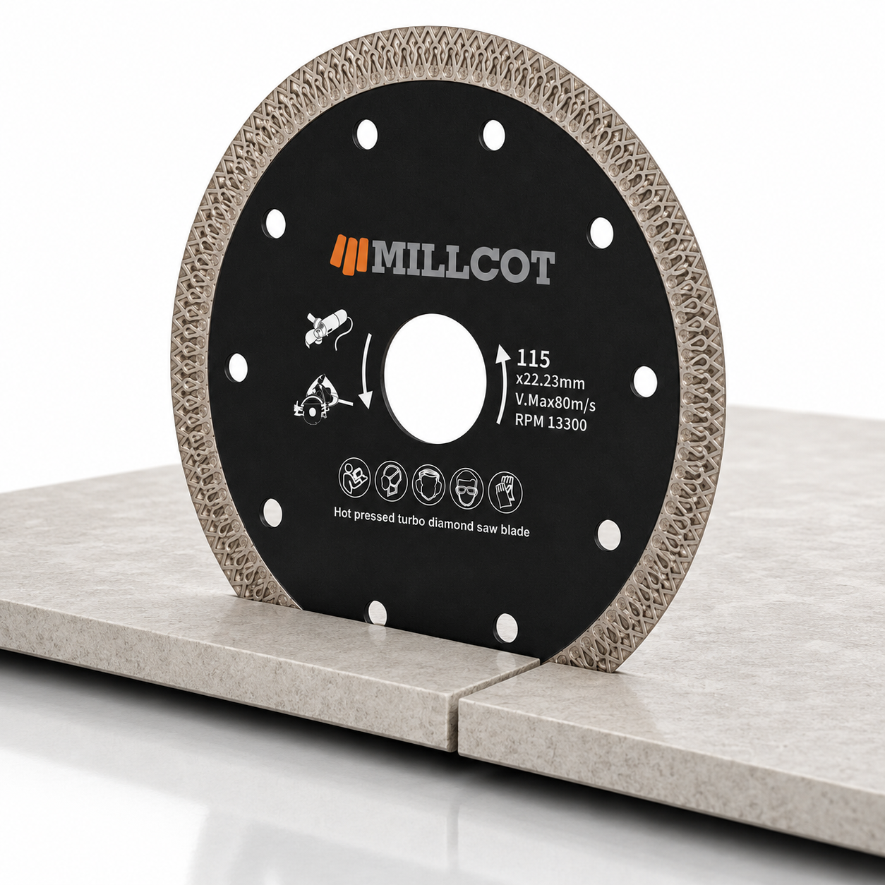 MILLCOT professional mesh diamond blade resting on a large-format porcelain tile, showing the 22.23mm bore and mesh-rim design for clean chip-free porcelain and ceramic cutting