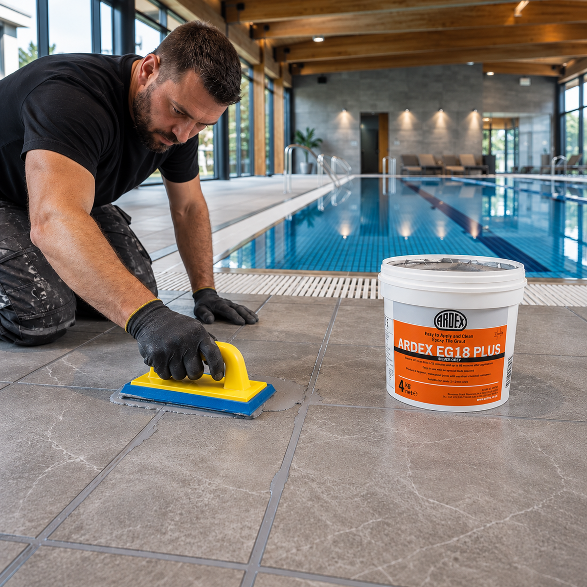 Tiler grouting poolside floor tiles with ARDEX EG18 and a Raimondi 1430 epoxy grout float