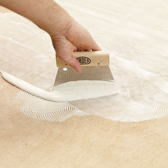 Step 2 of the Ardex AF200 Plus matting-installation process — applying the adhesive across the prepared subfloor.