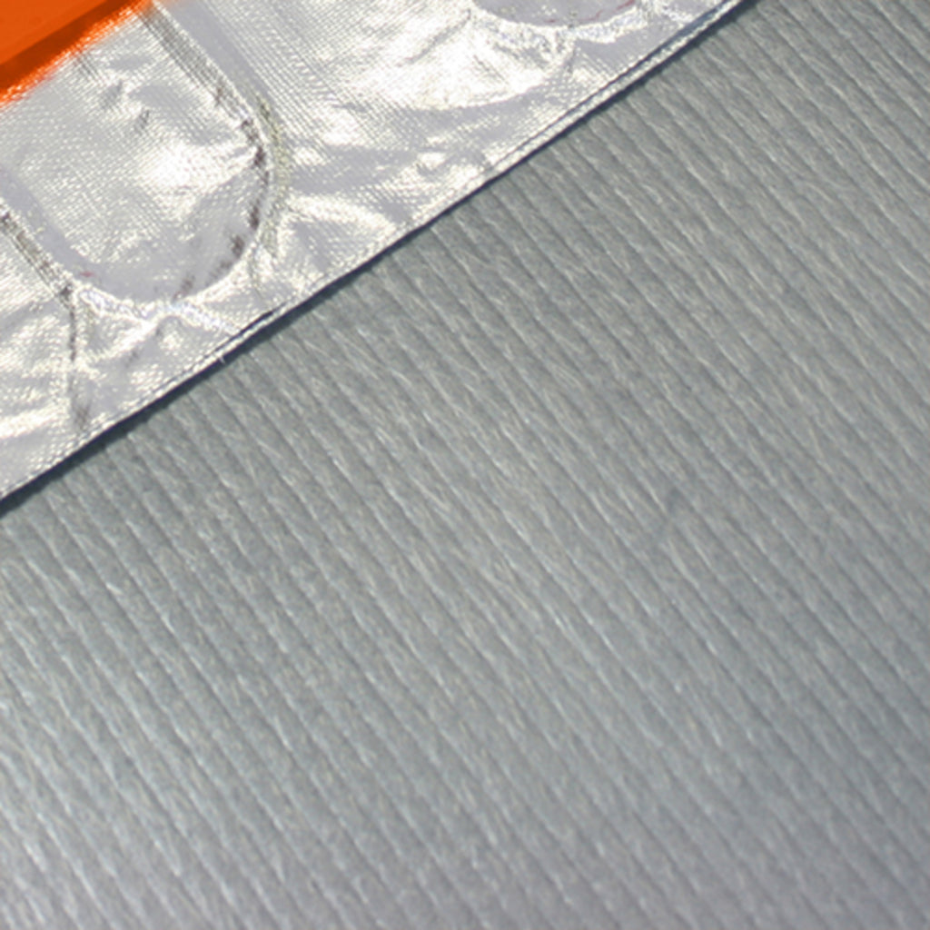 Close-up of a textured light gray fabric ThermoSphere Cushioning Underlay with a reflective silver foil trim and a small orange accent visible in the upper left corner.