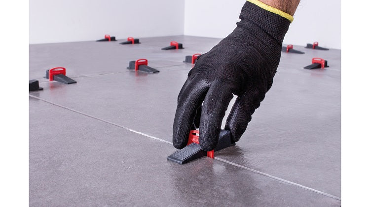 Rubi Delta Tile Levelling System — application view showing the strip installed under a tile during levelling.
